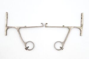 Pair of shelf and towel brackets with ring holders and mounting arms, shown as a matching pair.