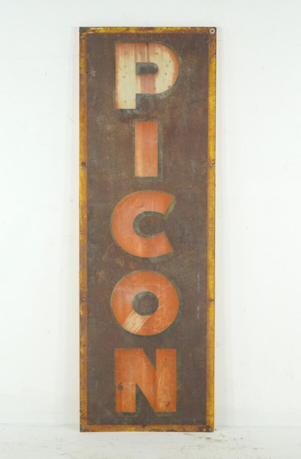 Vintage French Picon advertising sign in a tall rectangular format, showing stacked letters on a brown enamel steel panel with a worn multi-color finish and rusted edges.