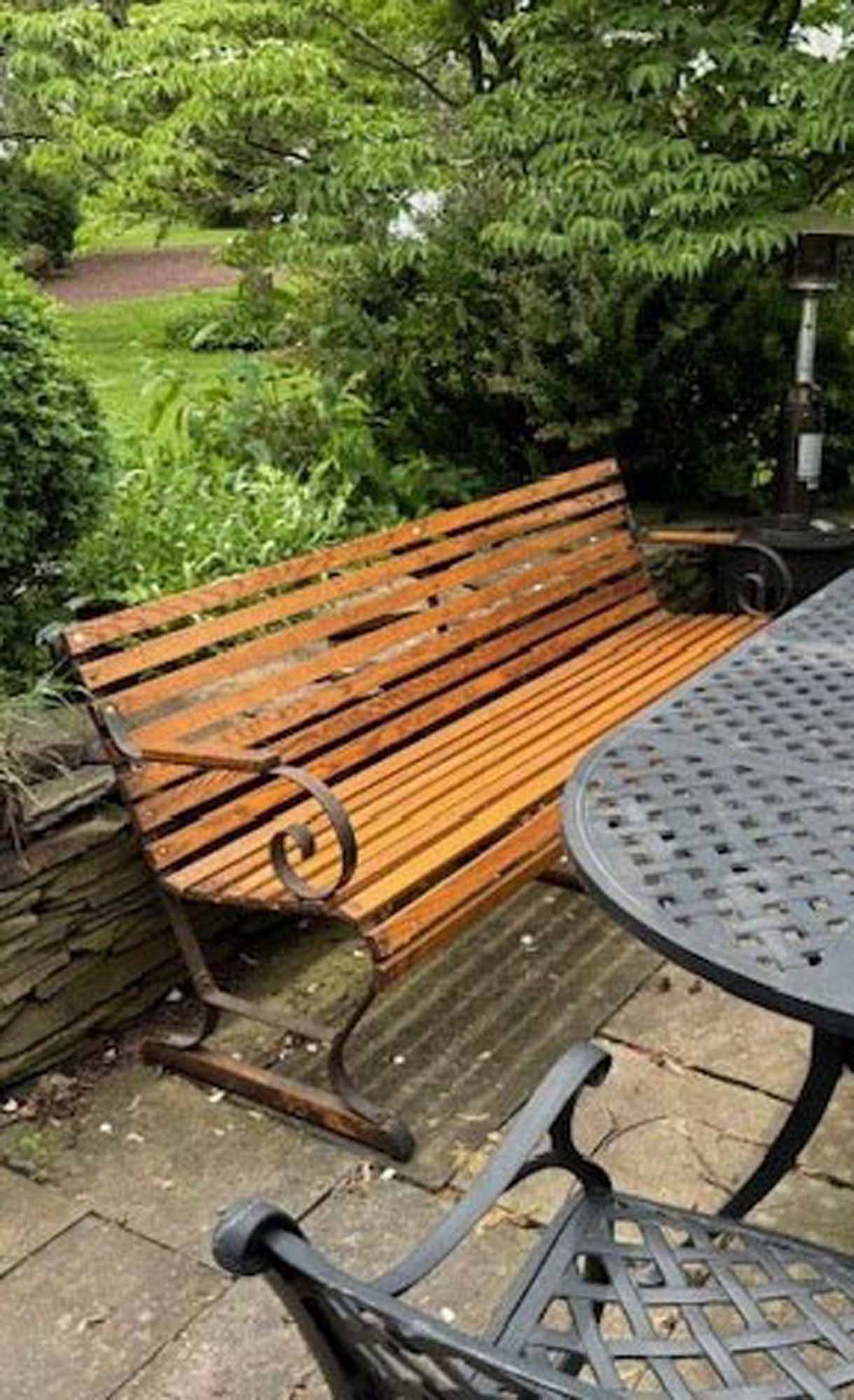 Belmont Racetrack wooden outdoor bench in a garden.