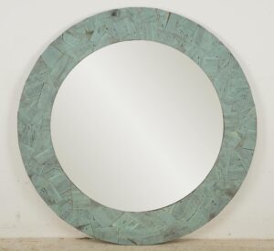 Round wall mirror with a verdigris copper collage frame and a large circular mirrored center.