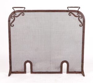 Antique wrought iron fireplace screen with fine netting, top handles, scrollwork corners, and two arched cutouts along the bottom edge.