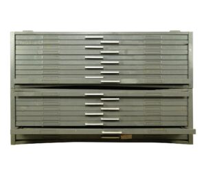 Gray steel flat filing cabinet with many shallow drawers, visible folding shelf sections, and a warped center opening. Surface wear and age marks are visible across the industrial cabinet.