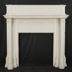 White Colonial Revival wooden mantel with rectangular frieze panels, a layered cornice shelf, and fluted pilasters, shown front on with visible paint cracks and surface wear.