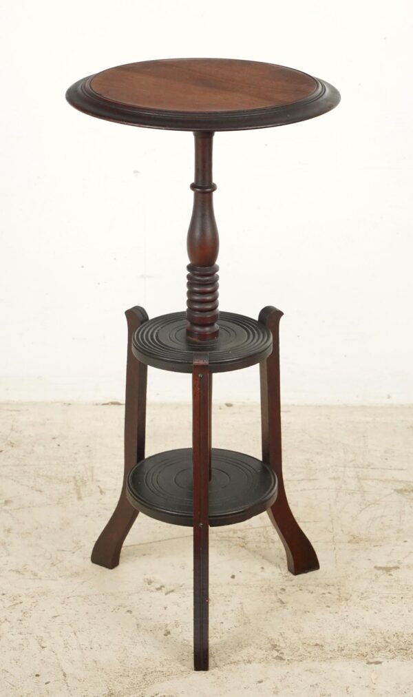 Victorian-style wooden plant stand with three display tiers and a turned central column in a dark wood tone.