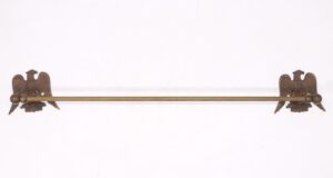 Antique brass towel bar with eagle motif wall brackets and a long rod.