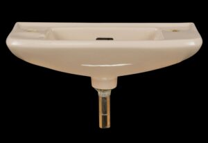 Tan ceramic wall sink with a square basin, side faucet holes, and visible drain hardware.