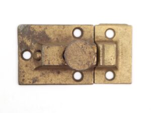 Vintage brushed brass cabinet latch with a worn finish, shown front view with four mounting holes and a round sliding catch.