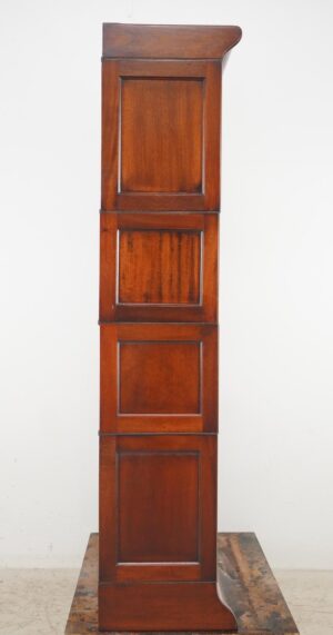 Tall Victorian-style wood barrister bookcase with four stacked sections and a curved top and base, shown in side view.