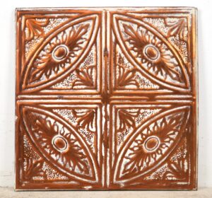 Handcrafted copper wall panel with an ornate four-quadrant geometric and floral tin-style pattern.